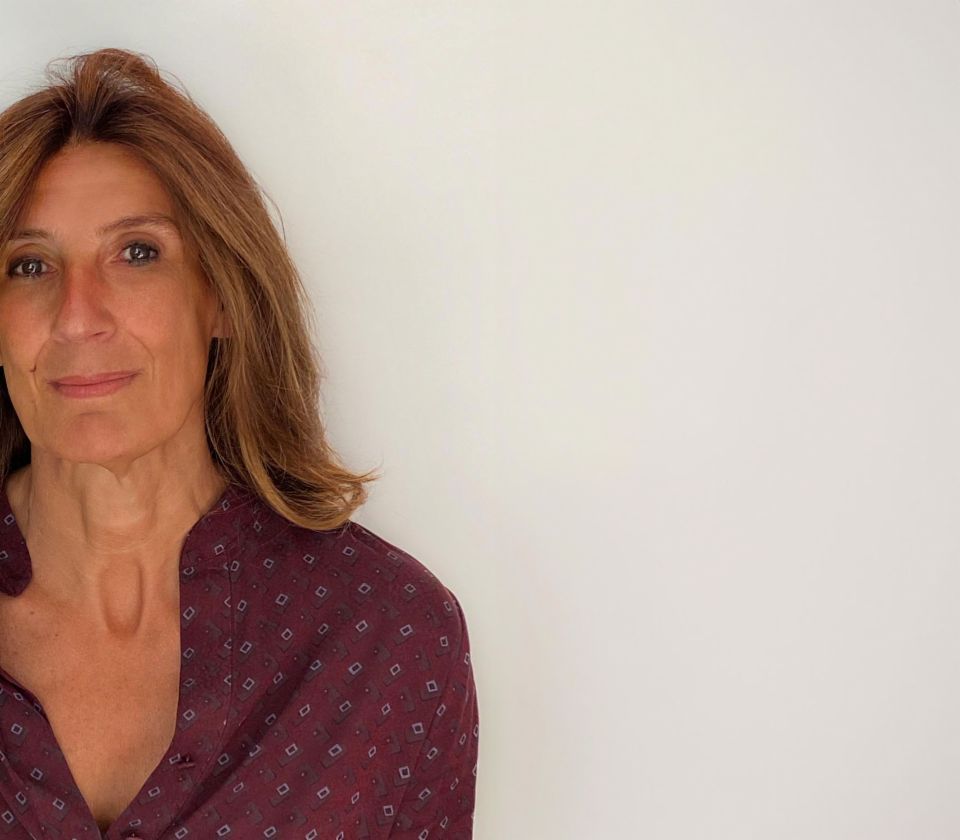 Portrait of Nathalie Lameyre, standing in a bright room