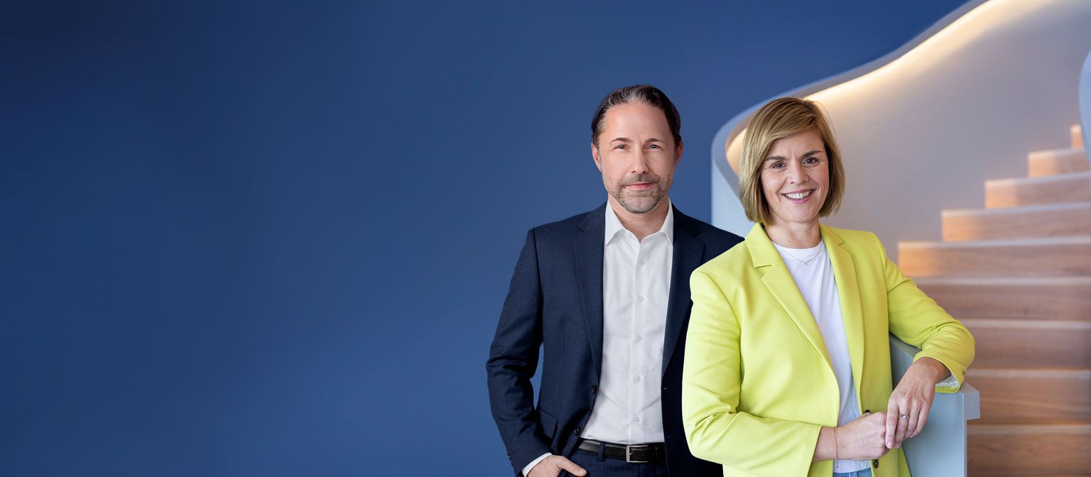 The image shows Marwin Ramcke, CEO of the EOS Group, and Dr. Eva Griewel, CFO of the EOS Group, together.