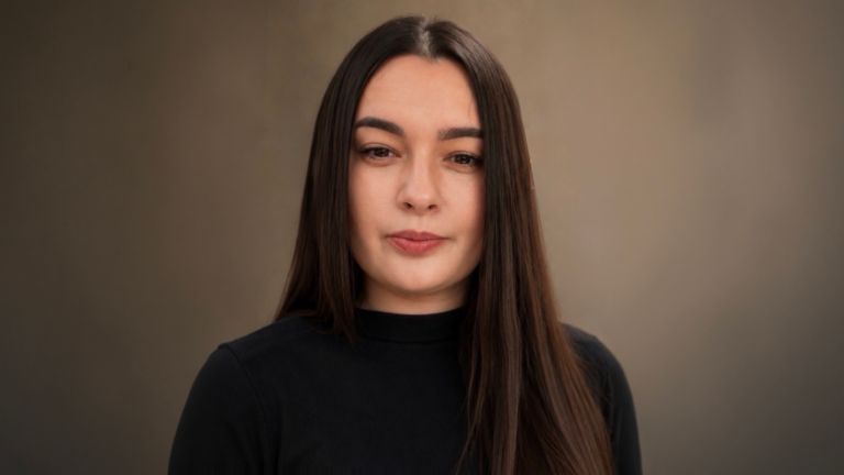 Daniela Moaca, Senior Manager IT at EOS Romania, portrait photo in a dark turtleneck.